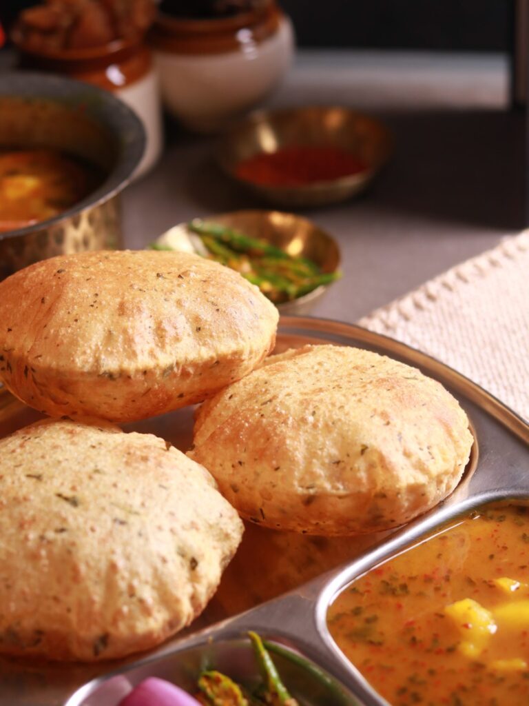 Steaming hot Poori served with potato curry