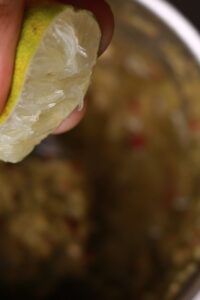 Fresh lime juice being squeezed.