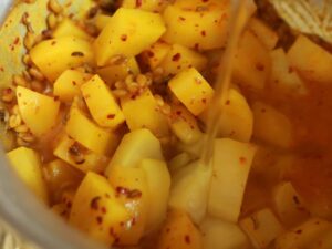 Adding water to curry.