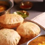 Steaming hot Poori served with potato curry