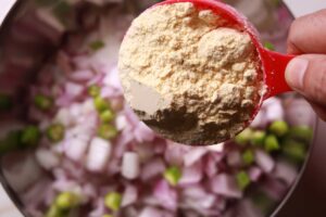 Mixing besan into the recipe