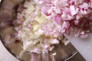 Adding diced onion to the dish