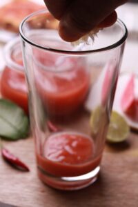 Lemon squeezing for tangy freshness.