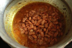 Rajma joins aromatic masala.