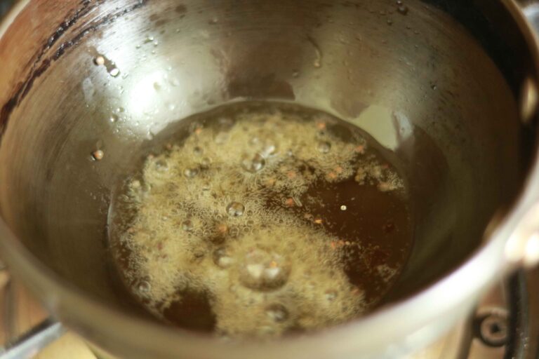 Adding Mustard seeds to the tempering.