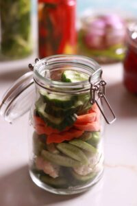 Vibrant veggie layers in jar.