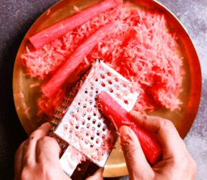 Gajar ka halwa: Grating carrots for aromatic halwa.
