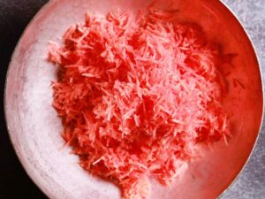 Gajar ka halwa - Fresh carrot grating in sizzling Kadai.