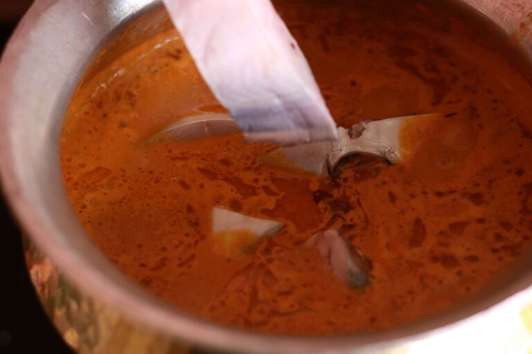 Fish into simmering curry.