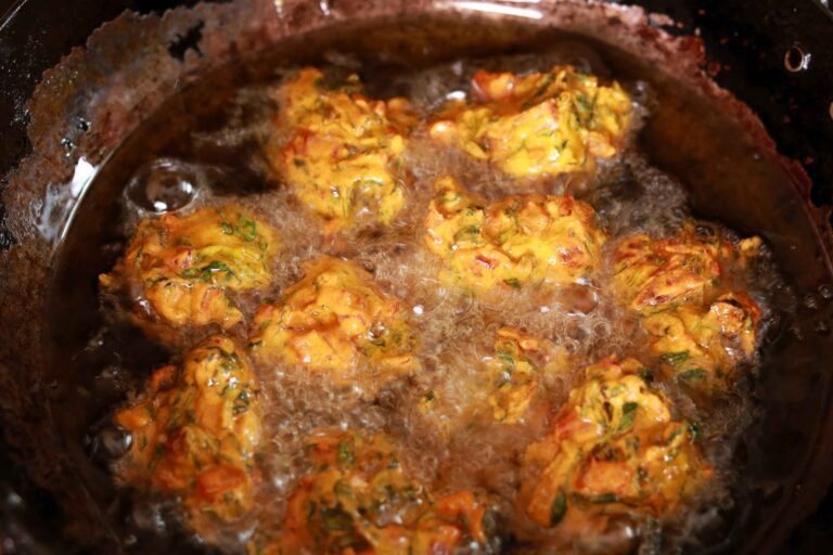 Crispy pakoras frying deliciously