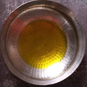 Sizzling oil in sturdy pot.