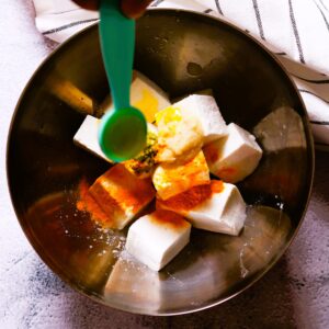 Paneer cubes in mixing bowl.