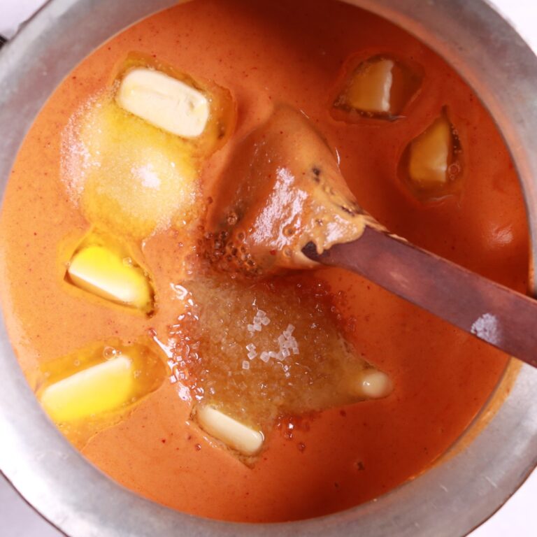 Adding tomato puree and butter in makhani sauce recipe