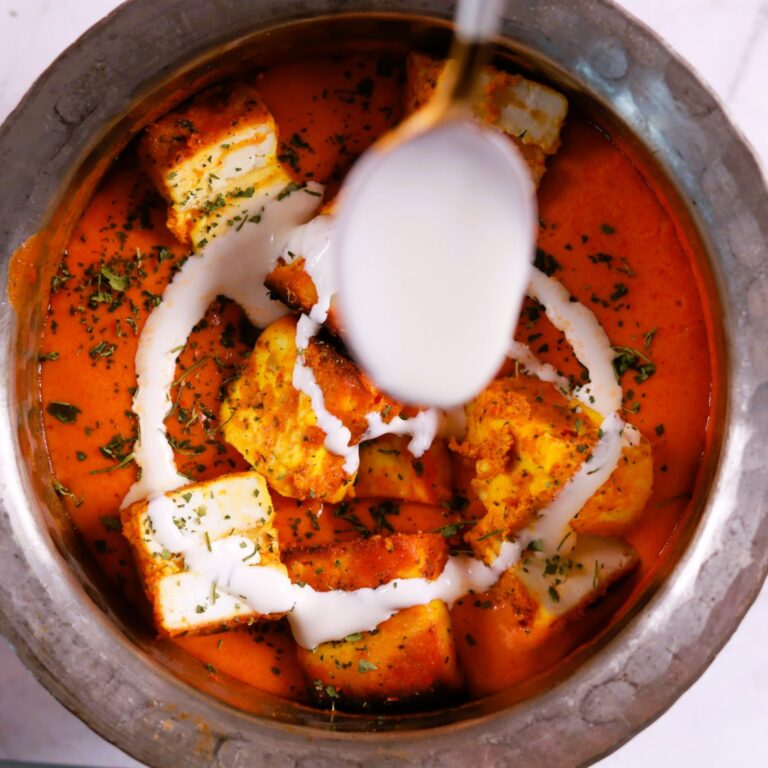 Creamy cooking cream stirred in panner makhani