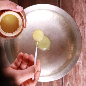 Ghee sizzling in pan.