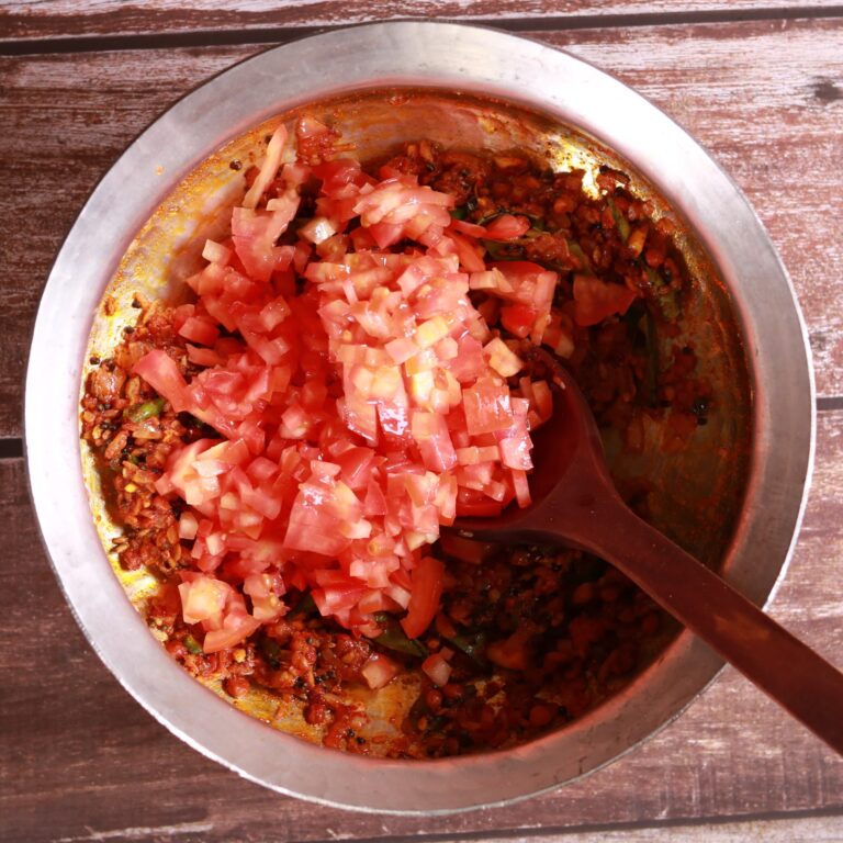 Tomatoes cooking in pan for Thakkali Sadam Recipe