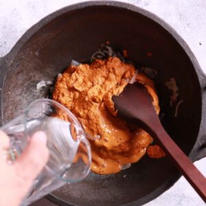 Adding water to Xec Xec masala