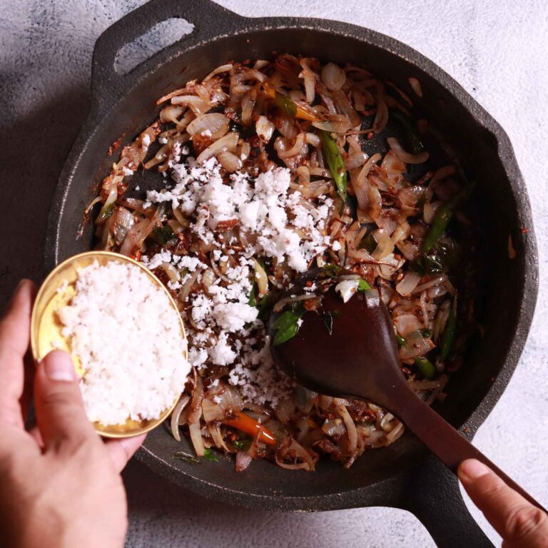 Adding grated coconut to skillet