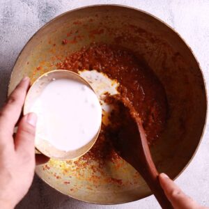 Preparing coconut milk mixture for chingri macher malai curry recipe