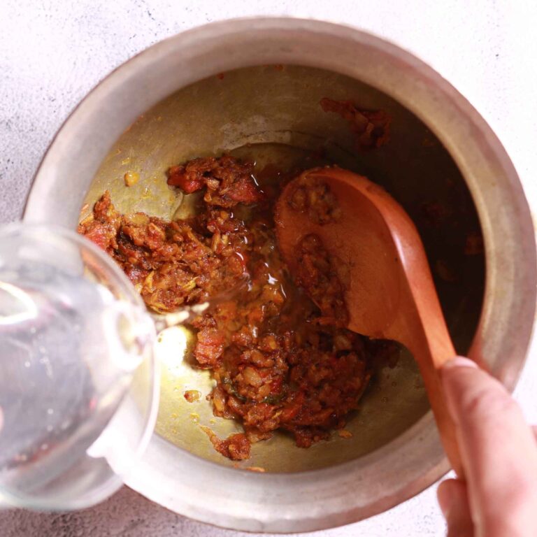 Adding water to masala