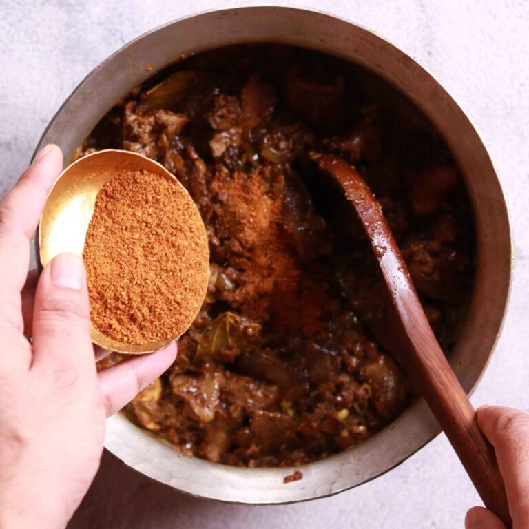 Adding chicken masala to the pan for chicken liver fry recipe