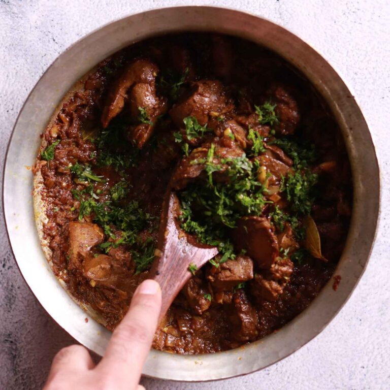 Adding chopped coriander to the chicken liver fry recipe