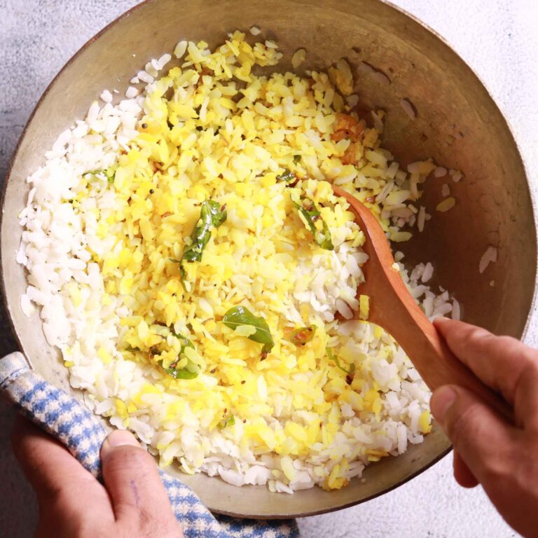 Folding poha into spices