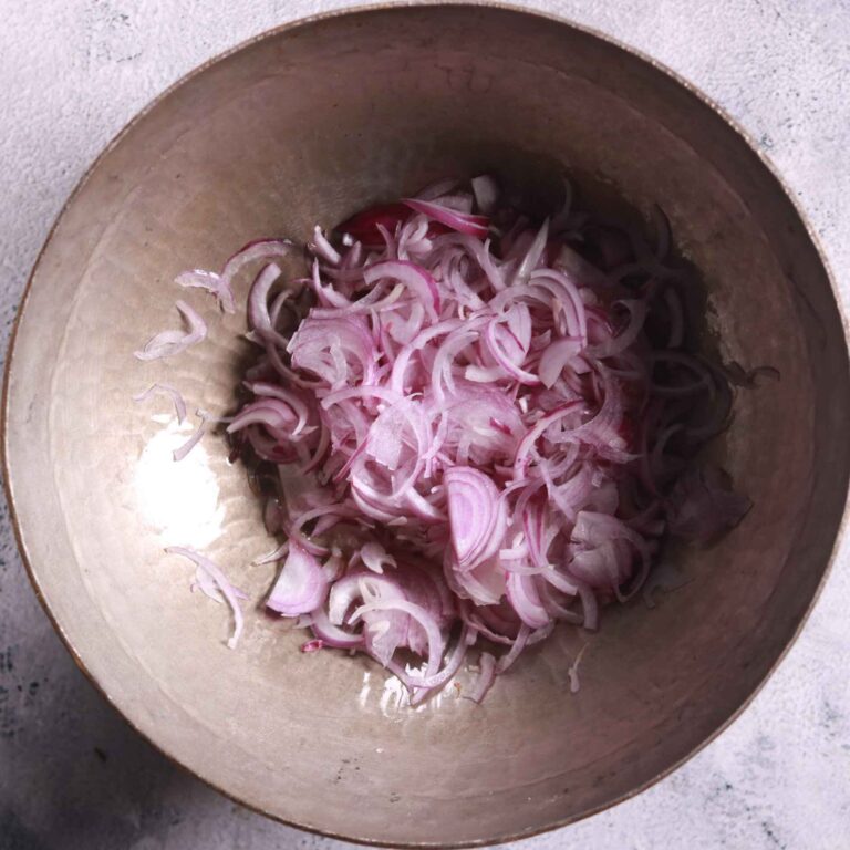 Sautéing sliced onions in ghee