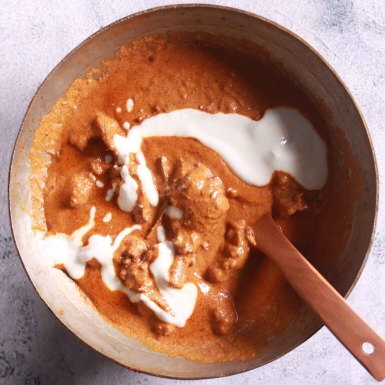 Adding cream and yoghurt to pan