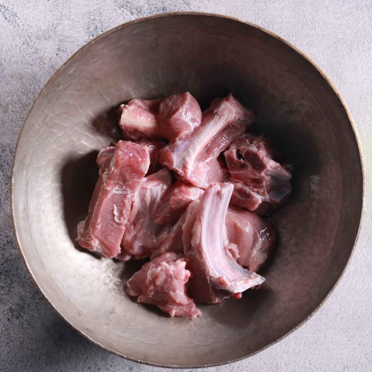 Washing mutton pieces in bowl