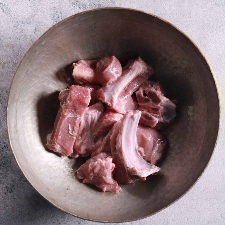 Washing mutton pieces in bowl