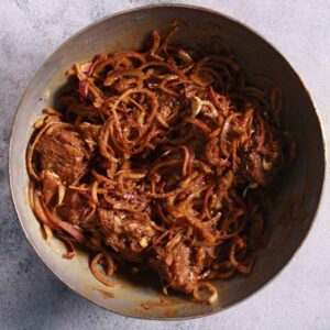 Mixing mutton with spices