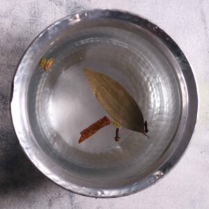 Adding spices and salt to boiling water