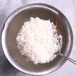 Straining partially cooked rice