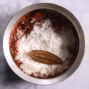 Layering rice over paneer