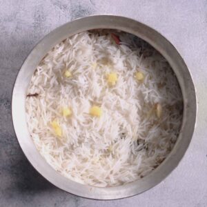 Pouring ghee and water over rice