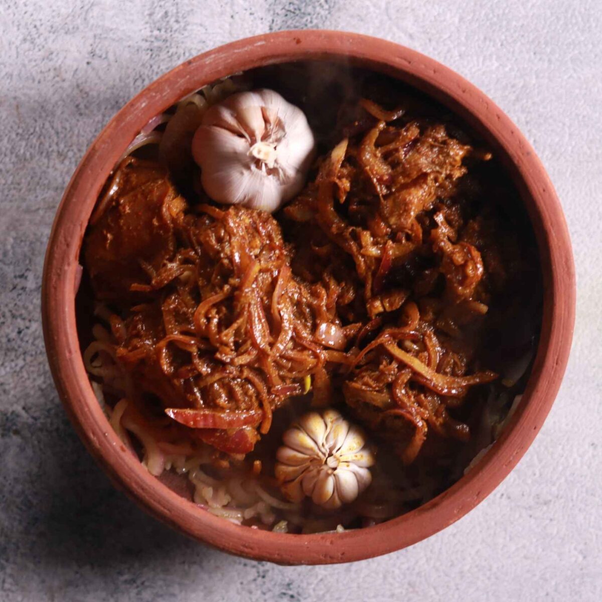 Adding marinated mutton to pot