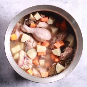 Adding vegetables to cooking chicken