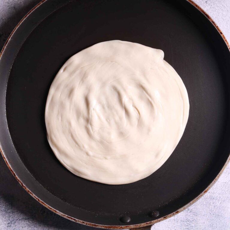 Placing parotha on pan