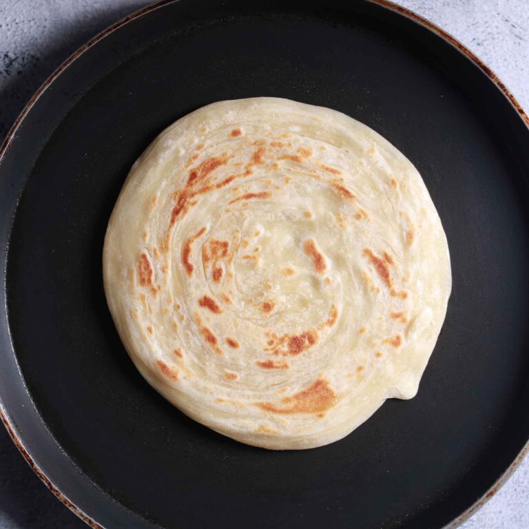 Cooking parotha on pan