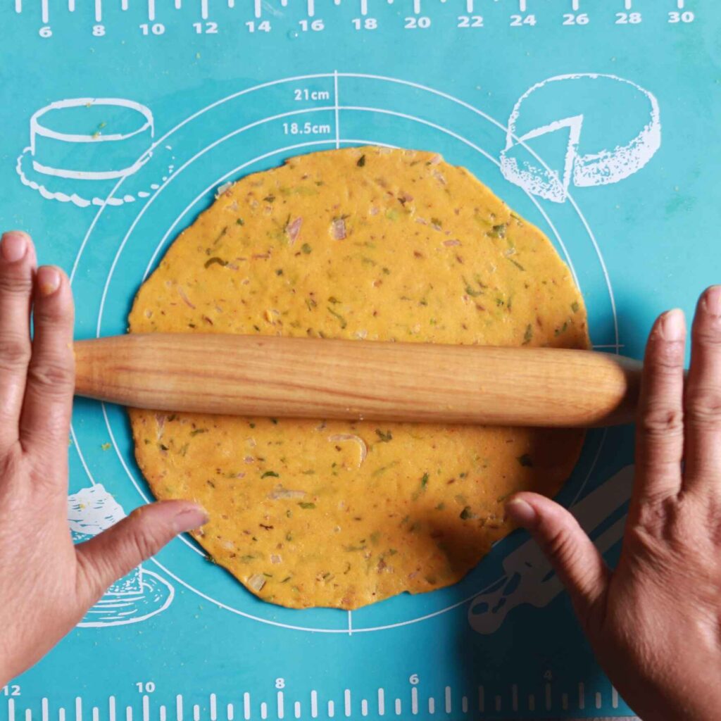 Rolling dough into roti