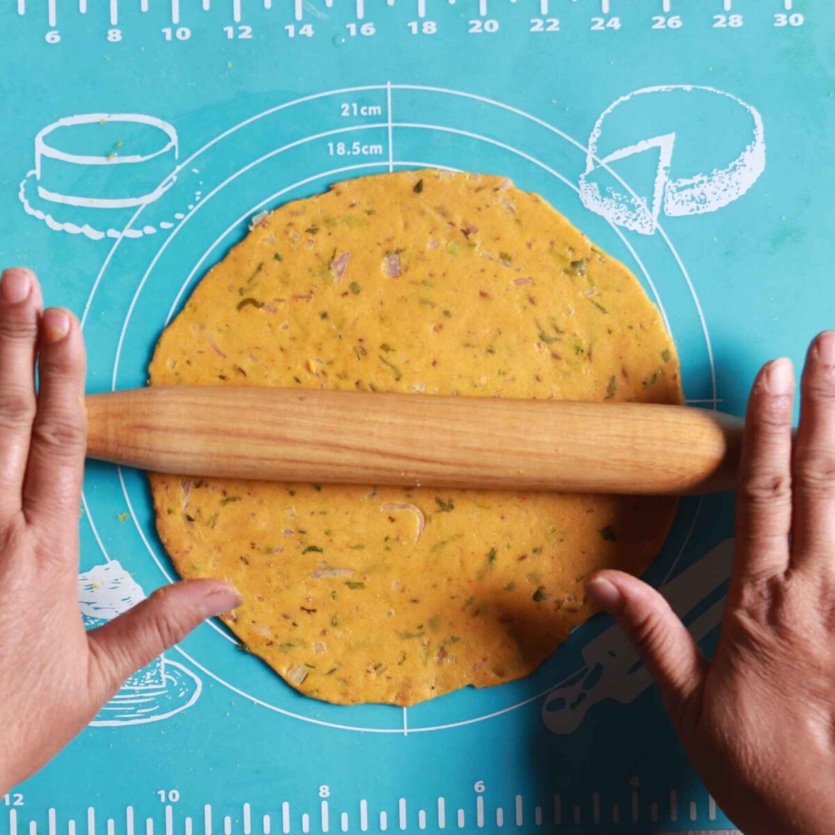 Rolling dough into roti