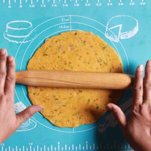 Rolling dough into roti