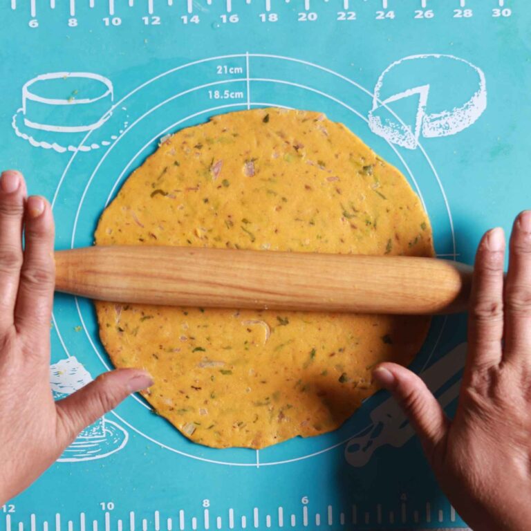 Rolling dough into roti