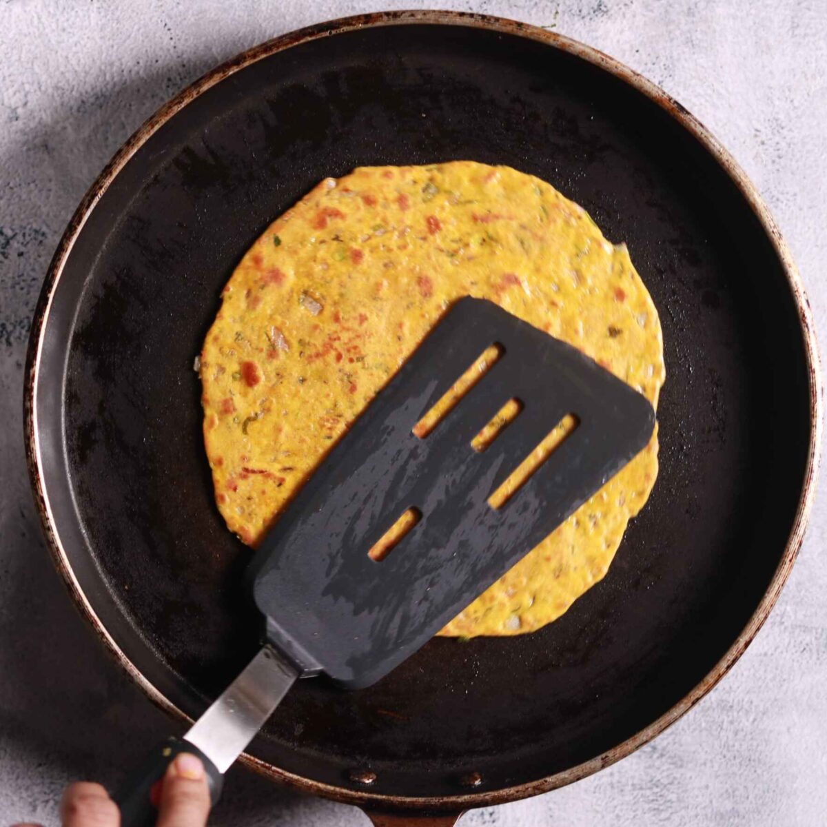 Heating tawa on stove