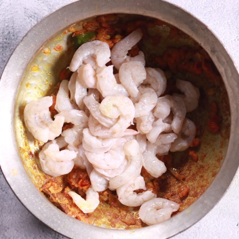 Sautéing prawns in masala