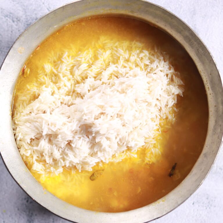 Adding rice and prawn masala