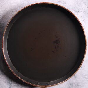 Heating greased tawa pan