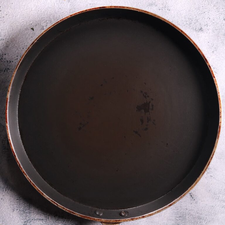 Heating greased tawa pan