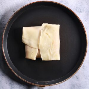 Folding dough over filling